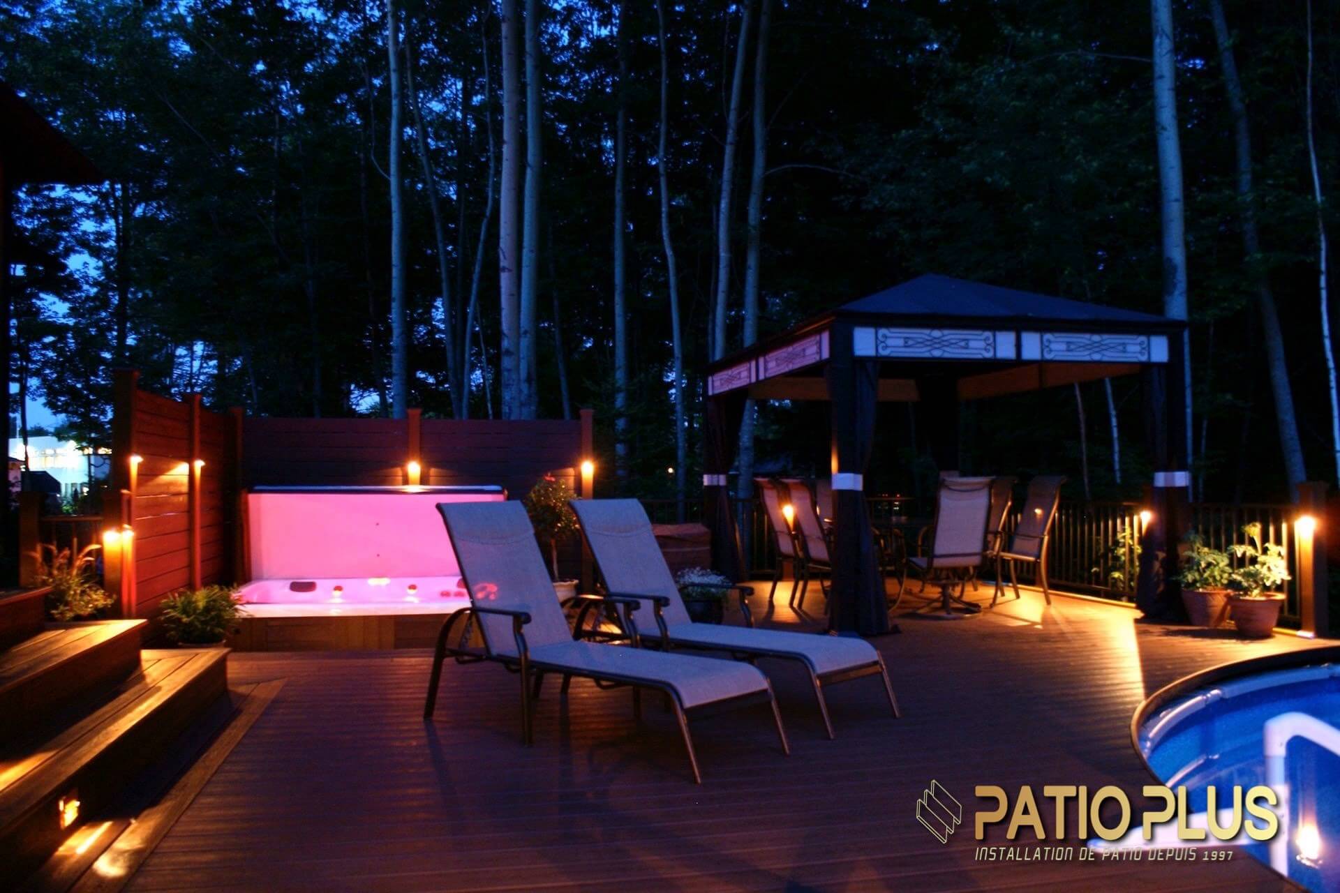 night image of a wooden deck with a spa